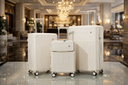 Ivory four-piece luggage set displayed in a hotel lobby
